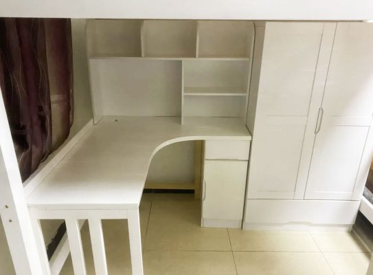 Physical photo: Book table and bookcase under white bed